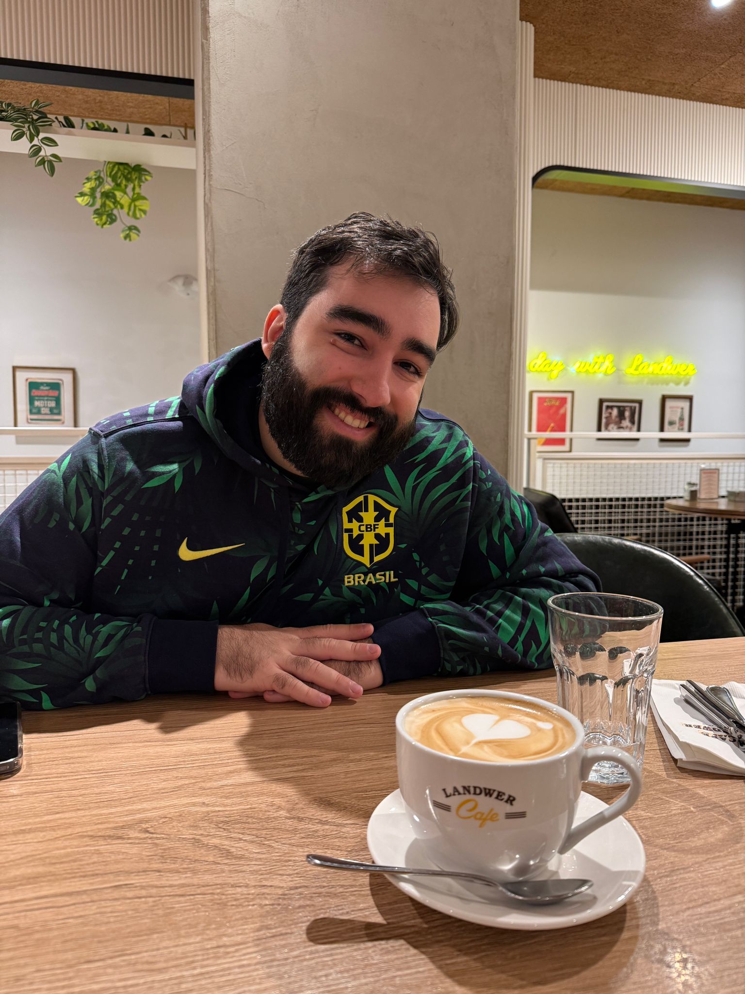 Portrait of the site author holding a latte at a cafe